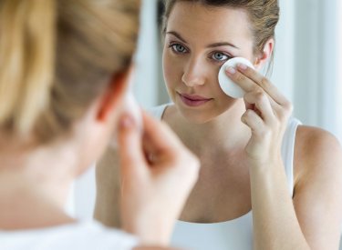 Woman cleaning her face